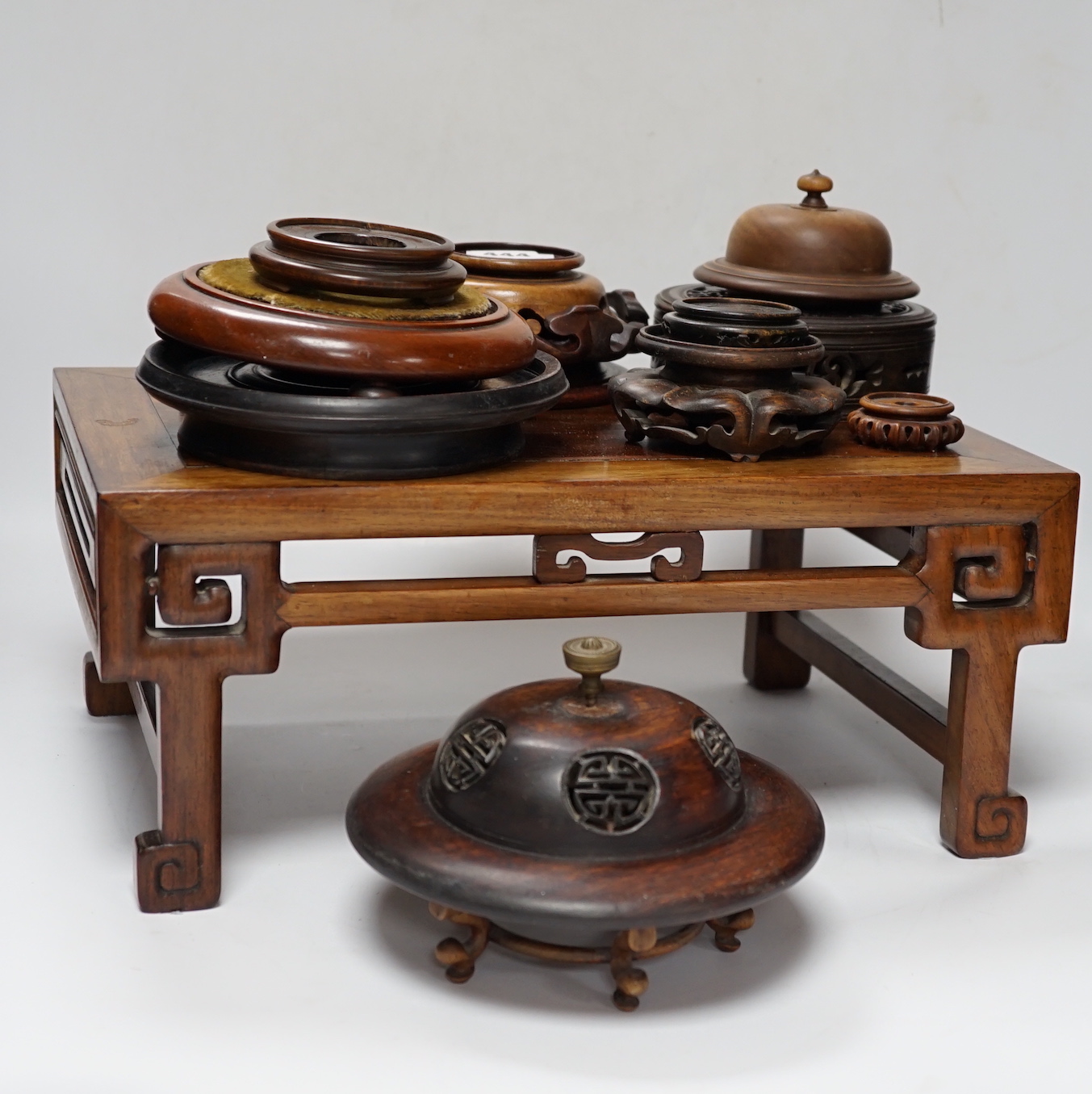 Nine Chinese hardwood vase stands, two hardwood covers and a Chinese hongmu table shaped stand, table 39cm x 25cm x 16.5cm